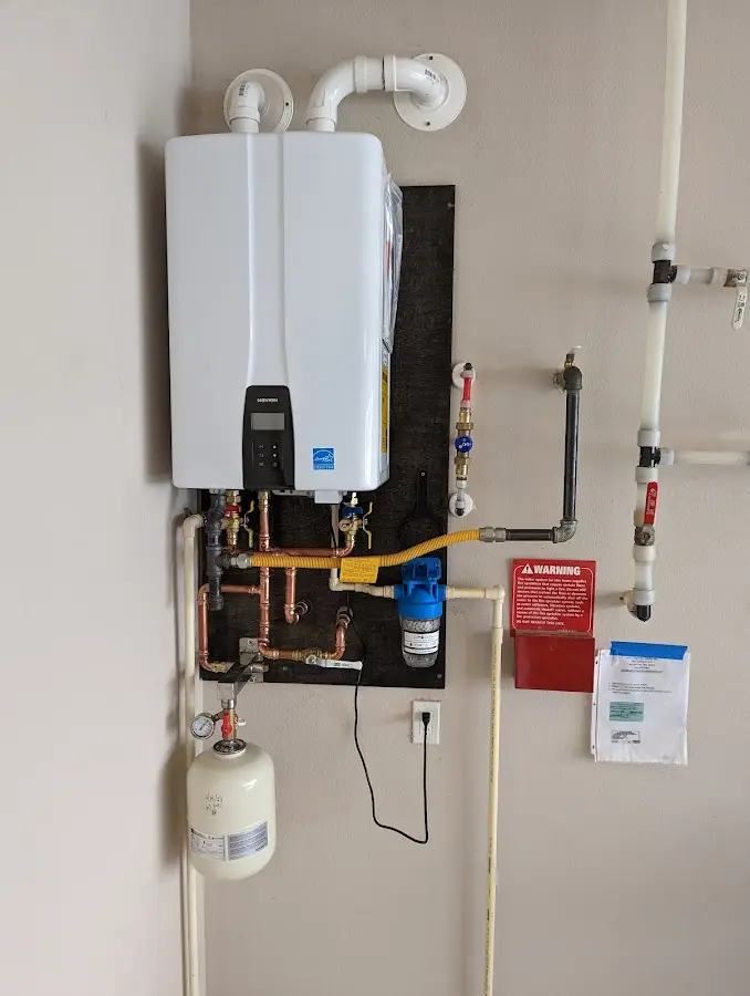 Professional plumber installing copper piping in a West Monroe home